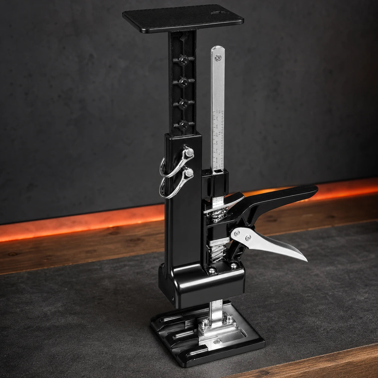 Close-up of the cabinet jack ratchet, release lever, scale rail, and steel base