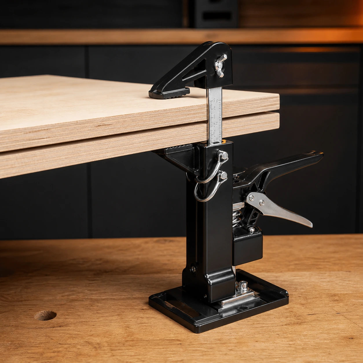 Cabinet jack converted to woodworking clamp mode on plywood panels